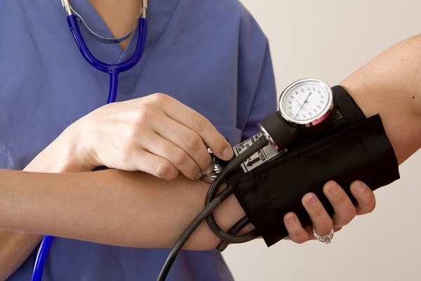 Doctor or nurse taking a patient’s blood pressure