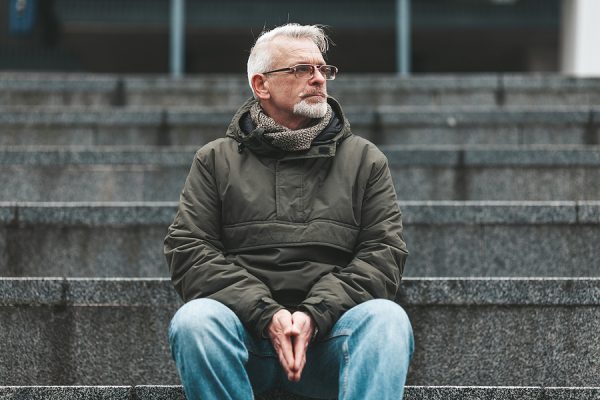 Lonely Old Man. A Gray-haired Man With Wrinkles Sits Outside, Sa