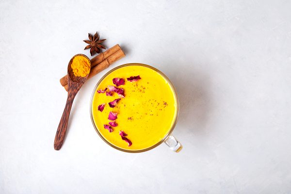 Indian Drink “golden Milk” Or Turmeric Latte, Decorated With Ros